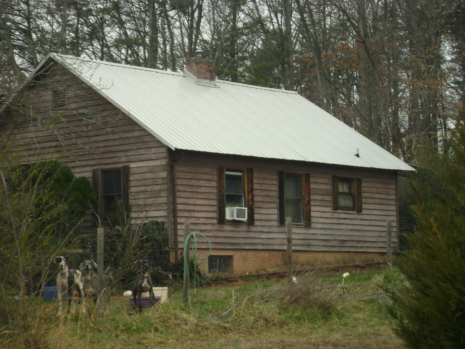 White metal roof on an old wood sided farmhouse, from a Asphalt Shingle Roof Repair job in Luxemburg
